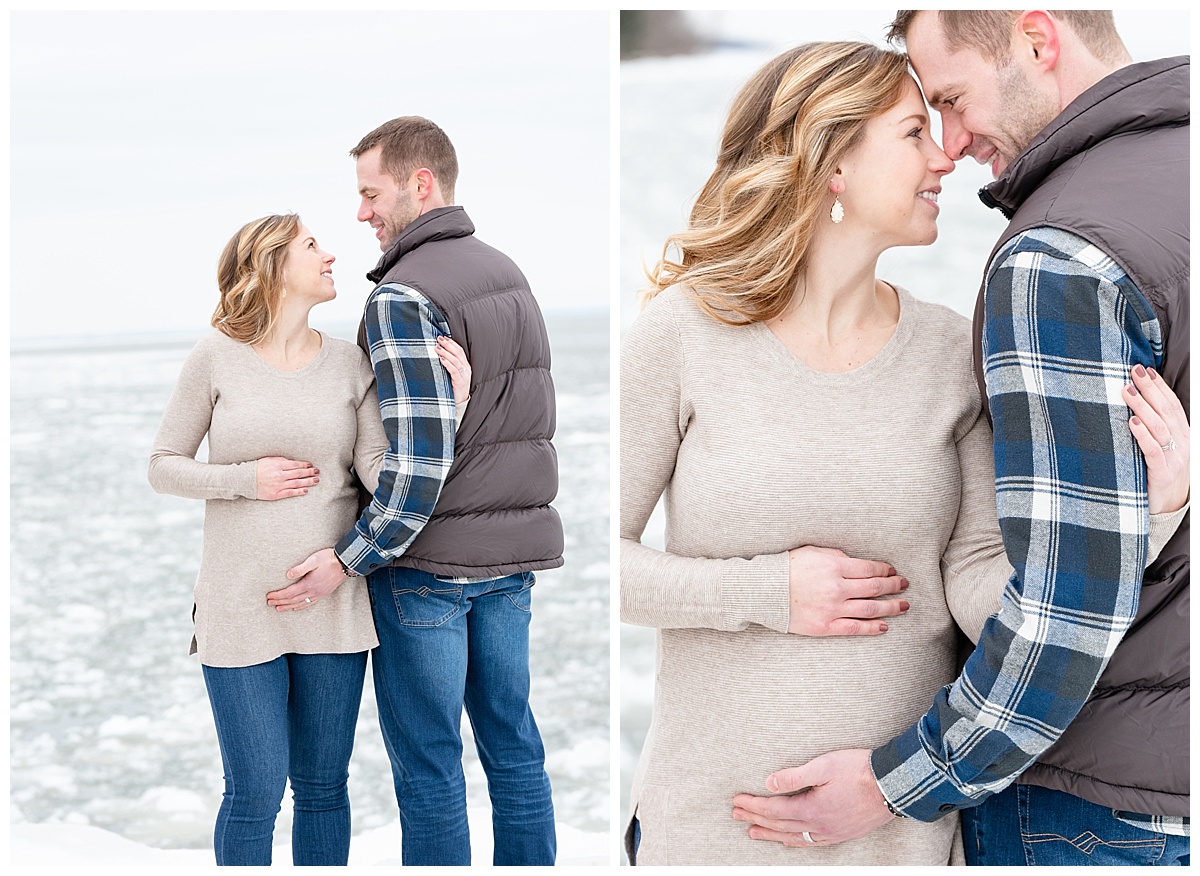 couple holding pregnant belly and smiling